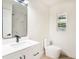 Bright bathroom featuring a white vanity, sleek black faucet, and modern finishes at 6208 S Harold Ave, Tampa, FL 33616