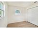 Bright bedroom featuring wood-look floors, a window, and a large closet at 6208 S Harold Ave, Tampa, FL 33616