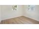 Bright bedroom with wood-look floors and two windows at 6208 S Harold Ave, Tampa, FL 33616
