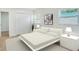 Stylishly staged bedroom featuring plush bedding, neutral colors and natural light at 6208 S Harold Ave, Tampa, FL 33616