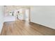 Bright empty room featuring hardwood floors and freshly painted white walls at 6208 S Harold Ave, Tampa, FL 33616