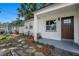 The property features a manicured lawn, stepping stone walkway, and brown front door at 6208 S Harold Ave, Tampa, FL 33616