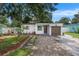 Charming home featuring a well-manicured lawn, quaint walkway, and attached one car garage at 6208 S Harold Ave, Tampa, FL 33616