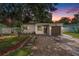 Charming home featuring a well-manicured lawn, quaint walkway, and attached one car garage at 6208 S Harold Ave, Tampa, FL 33616