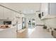 Modern kitchen with white cabinets, quartz countertops, and stainless steel appliances at 6208 S Harold Ave, Tampa, FL 33616