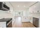Newly remodeled kitchen with modern appliances and a view to the entry of the home at 6208 S Harold Ave, Tampa, FL 33616