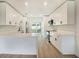 Modern kitchen features white cabinets, quartz countertops, and stainless steel appliances at 6208 S Harold Ave, Tampa, FL 33616