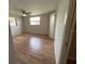 Cozy bedroom with laminate flooring, a ceiling fan, and ample natural light at 7240 Rosarian Dr, Port Richey, FL 34668