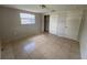 Bedroom showcasing neutral walls, tile flooring, window and closet at 7240 Rosarian Dr, Port Richey, FL 34668