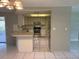 Open-concept kitchen with stainless steel appliances and tile flooring at 7240 Rosarian Dr, Port Richey, FL 34668