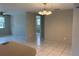 Open living and dining area with tile floors and modern lighting fixtures at 7240 Rosarian Dr, Port Richey, FL 34668