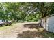 Expansive backyard featuring mature trees, a small shed, and plenty of room for outdoor activities at 26627 Brahma Dr, Wesley Chapel, FL 33544