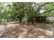 Backyard featuring mature trees and home with accessibility ramp at 26627 Brahma Dr, Wesley Chapel, FL 33544