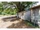 View of the backyard featuring outbuildings, sheds and trees at 26627 Brahma Dr, Wesley Chapel, FL 33544
