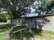 View of backyard shed, outbuilding, and trees behind a fence at 26627 Brahma Dr, Wesley Chapel, FL 33544