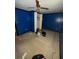 Bedroom featuring blue walls, carpet flooring, and a ceiling fan at 26627 Brahma Dr, Wesley Chapel, FL 33544