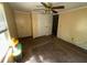 Bedroom with yellow walls, carpet flooring, and a ceiling fan at 26627 Brahma Dr, Wesley Chapel, FL 33544