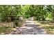 Gated driveway leading to home and detached garage at 26627 Brahma Dr, Wesley Chapel, FL 33544