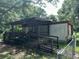 Quaint home with covered entry ramp and mature trees at 26627 Brahma Dr, Wesley Chapel, FL 33544