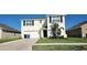 Charming two-story home with a well-manicured lawn and attached two-car garage at 16650 Windmill Forge Pass, Wimauma, FL 33598