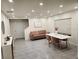 Contemporary living room featuring neutral walls, tiled floors, and minimalist furniture at 16650 Windmill Forge Pass, Wimauma, FL 33598