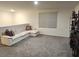 Relaxing living room with neutral walls, a window, and a comfortable sectional sofa at 16650 Windmill Forge Pass, Wimauma, FL 33598