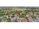 Aerial view showcasing the home's location surrounded by lush greenery, mature trees, and nearby community amenities at 11019 Pine Lilly Pl, Lakewood Ranch, FL 34202