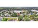 Aerial view of home featuring mature trees and landscaping, a large pool and proximity to community amenities at 11019 Pine Lilly Pl, Lakewood Ranch, FL 34202
