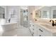Luxurious bathroom featuring a soaking tub, walk-in shower, and double vanity at 11019 Pine Lilly Pl, Lakewood Ranch, FL 34202