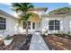 Inviting front entrance showcasing a well-maintained walkway, lush landscaping, and an arched doorway at 11019 Pine Lilly Pl, Lakewood Ranch, FL 34202