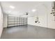 Spacious garage with speckled epoxy flooring and an automatic door offering convenient parking and storage at 11019 Pine Lilly Pl, Lakewood Ranch, FL 34202