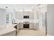 Contemporary kitchen with sleek white countertops, stainless steel appliances, and minimalist cabinetry at 11019 Pine Lilly Pl, Lakewood Ranch, FL 34202