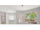 Bright living room featuring neutral walls, modern lighting, and large windows overlooking the lush outdoors at 11019 Pine Lilly Pl, Lakewood Ranch, FL 34202