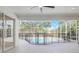 The covered patio overlooks the screened pool with a safety fence at 11019 Pine Lilly Pl, Lakewood Ranch, FL 34202