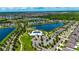 Aerial view of a community showcasing the clubhouse, pool, and surrounding neighborhood at 11124 Leland Groves Dr, Riverview, FL 33579