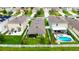An aerial view showcasing a landscaped backyard with pool, and fenced yard at 11124 Leland Groves Dr, Riverview, FL 33579