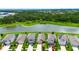 Overhead view of a neighborhood with houses lining a street, backing onto a scenic pond at 11124 Leland Groves Dr, Riverview, FL 33579