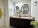 Bright bathroom with double vanity, framed mirrors, and neutral décor creating a serene and inviting atmosphere at 11124 Leland Groves Dr, Riverview, FL 33579