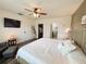 Bright bedroom featuring wood floors, ceiling fan, and a closet leading to a bathroom at 11124 Leland Groves Dr, Riverview, FL 33579