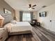 Bright bedroom with wood floors, ceiling fan, and a window providing natural light at 11124 Leland Groves Dr, Riverview, FL 33579
