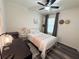 Inviting bedroom featuring a ceiling fan, wood-look floors, and a metal bed frame for a cozy feel at 11124 Leland Groves Dr, Riverview, FL 33579