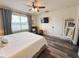 Bright bedroom with wood floors, ceiling fan, and a window providing natural light at 11124 Leland Groves Dr, Riverview, FL 33579