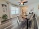 Dining room with modern table and chairs, decorative accents, and window with natural light at 11124 Leland Groves Dr, Riverview, FL 33579