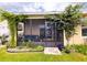 Charming home with a screened lanai surrounded by vibrant greenery and beautiful climbing vines at 11124 Leland Groves Dr, Riverview, FL 33579