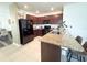 Modern kitchen with granite countertops, dark cabinets, stainless steel appliances and breakfast bar seating at 11124 Leland Groves Dr, Riverview, FL 33579