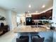 Open kitchen featuring granite countertops and stainless steel sink overlooking a dining area at 11124 Leland Groves Dr, Riverview, FL 33579