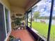 View from the lanai looking out to the large, well-manicured lawn and waterfront view at 11124 Leland Groves Dr, Riverview, FL 33579