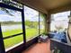 Screened lanai offers a relaxing sitting area and lush view of the green backyard and pond at 11124 Leland Groves Dr, Riverview, FL 33579