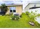 Side yard showcases a manicured lawn, thriving garden, and a functional AC unit at 11124 Leland Groves Dr, Riverview, FL 33579