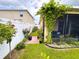 Side yard featuring a lush garden, blossoming flowers, paved walkway, and an abundance of greenery at 11124 Leland Groves Dr, Riverview, FL 33579